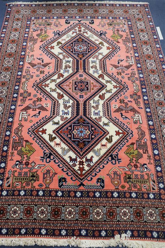 A Persian pink ground rug, 204 x 136cm